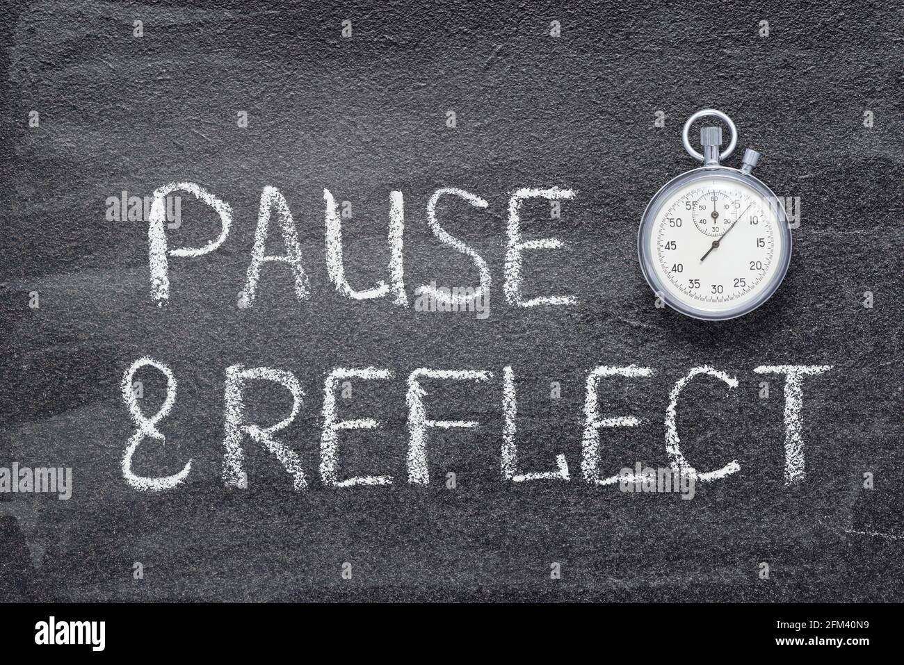 pause-and-reflect-phrase-written-on-chalkboard-with-vintage-precise-stopwatch-2FM40N9